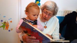 ABC Pediatric Therapy Grandma and Infant looking at book